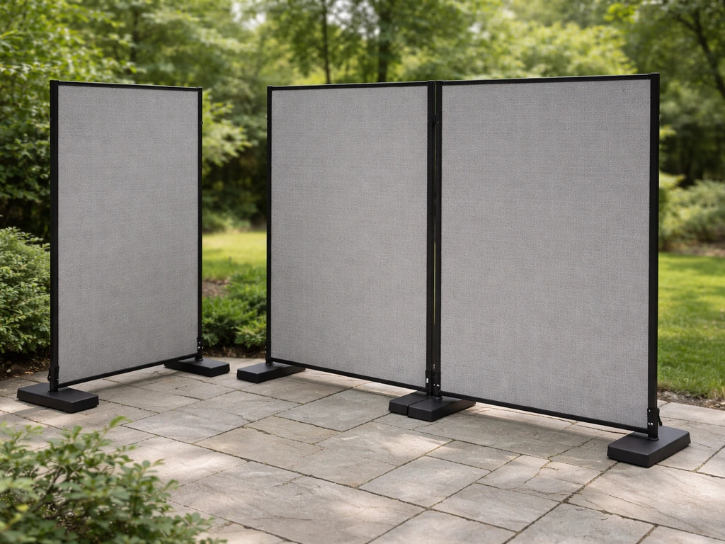 Freestanding modular privacy panels aligned along a patio edge on weighted bases.